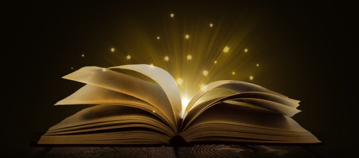 Image of opened magic book with magic lights